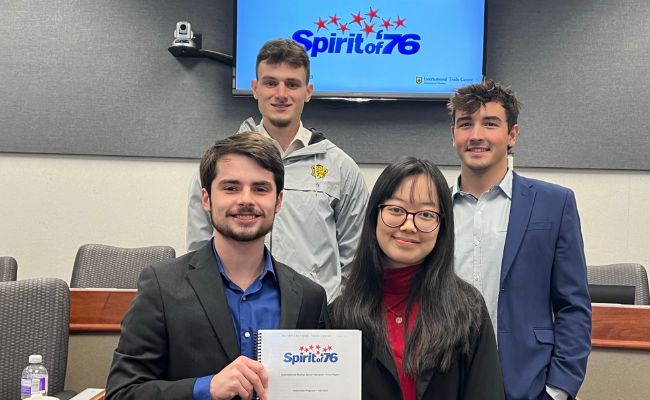 Group of International Trade Center interns pose for a group photo after final presentation