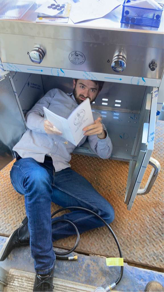 Alex McCarty assembles a grill.