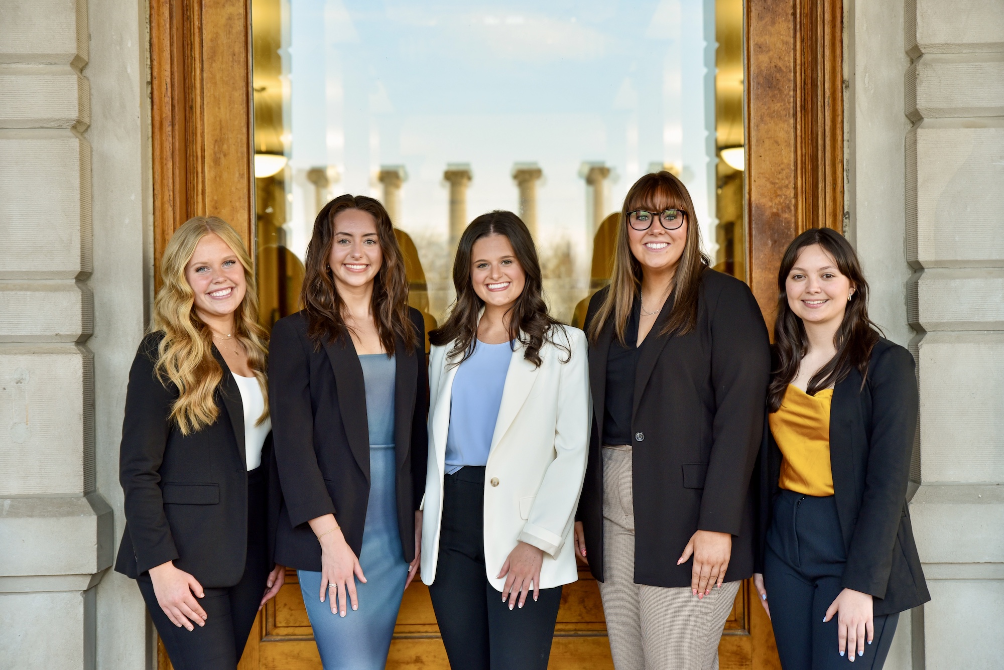Image: group of five female business students pose for group photo