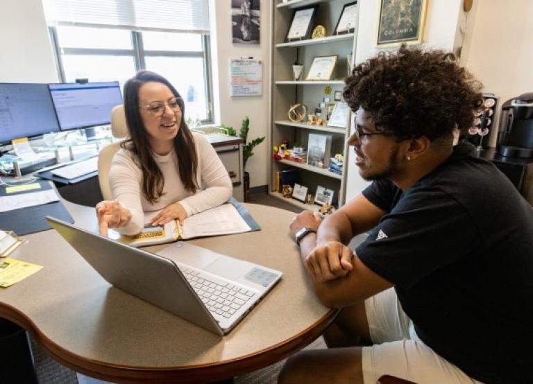 Councilor helps student pick his schedule for the semester