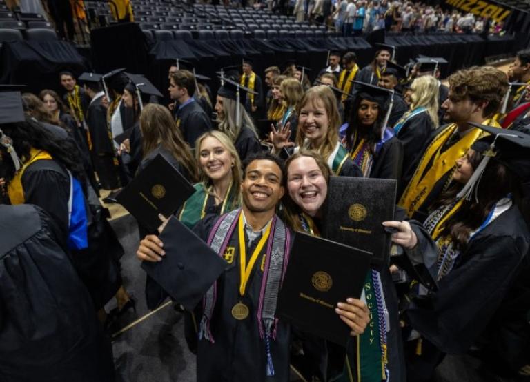 Students pose at graduation