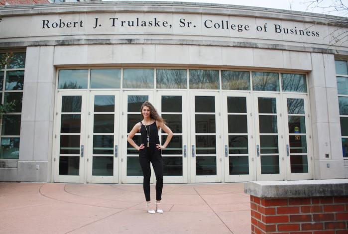 Kaitlyn Berry with her hands on her hips, standing outside of Cornell Hall