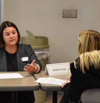 Assistant teaching professor Shannon Breske leading a case study and debrief