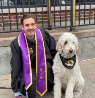Bauer and MO snap a picture in their graduation regalia outside one of their favorite Columbia restaurants, Campus Bar  & Grill.